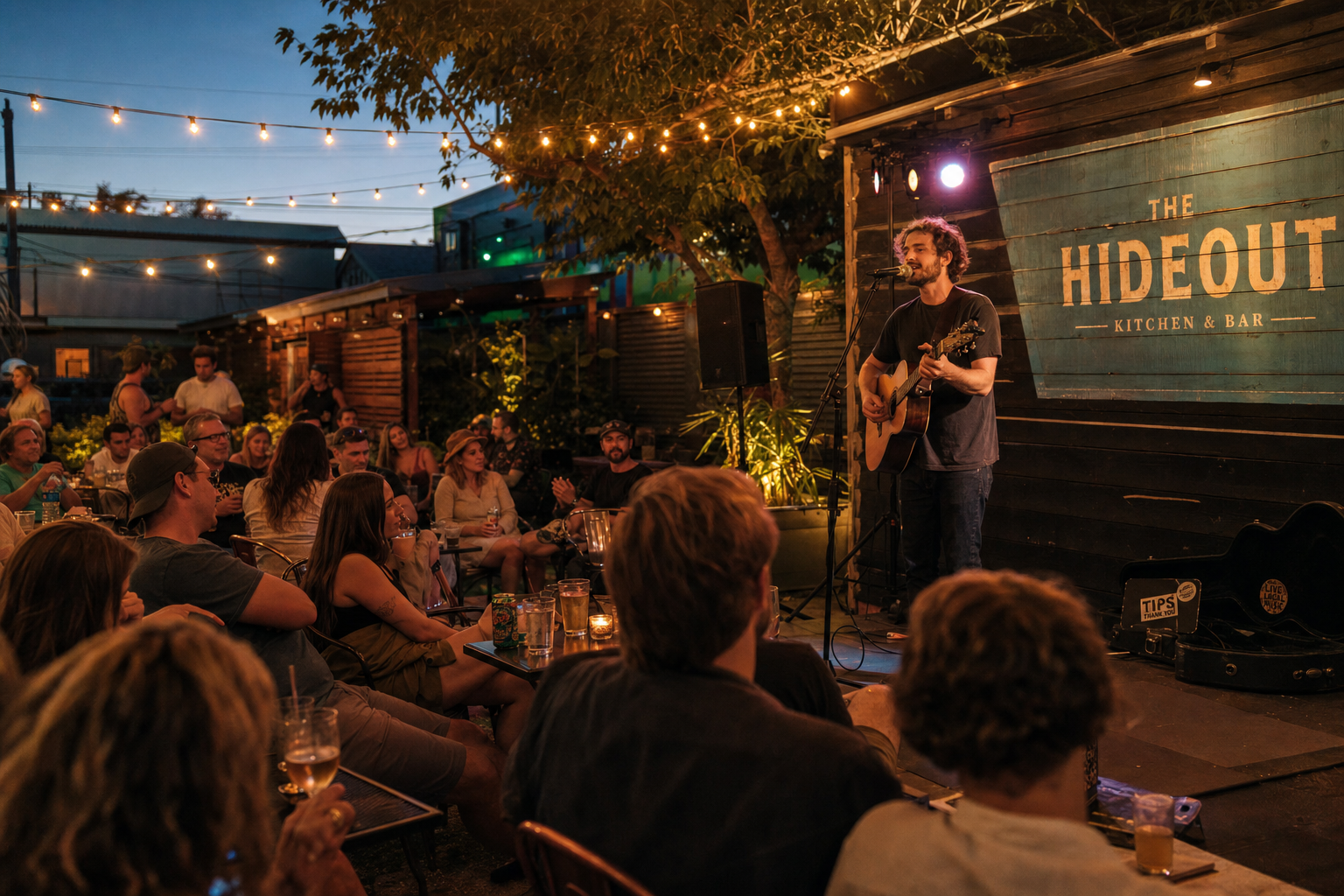 Performing artist playing on a restaurant patio stage